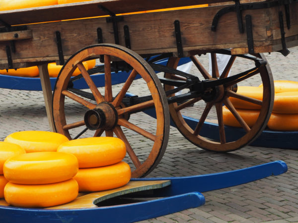 Man with carrier cheese on a famous market place